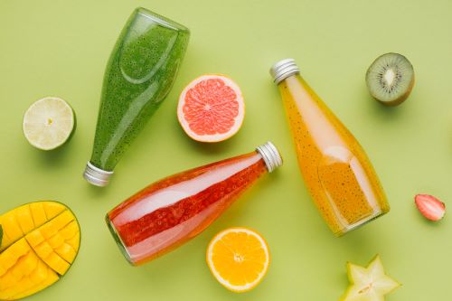 colorful-juice-bottles-fruit-slices_23-2148227558.jpg